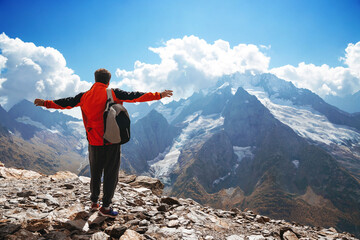 Tourist man backpacking raise hands feel the sun shining, successful concept.