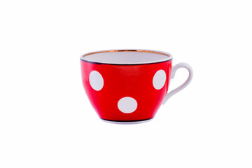 Ceramic red cup with white polka dots isolated on white background. Copy space.