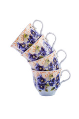 Close-up set of beautiful cobalt white vintage porcelain tea cups with floral pattern on white...