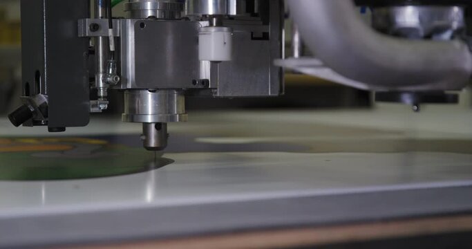 Close Up Of An Industrial Stencil Cutting Machine Cutting Out Shape.