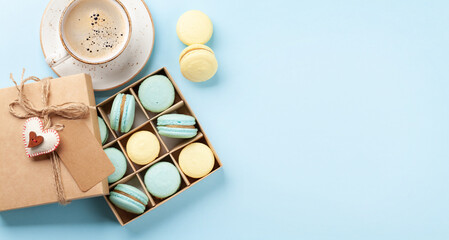 Homemade macaroons in gift box and coffee