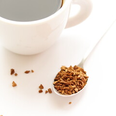 Chicory drink in spoon, in cup, isolated on table, on white background. Instant coffee.	