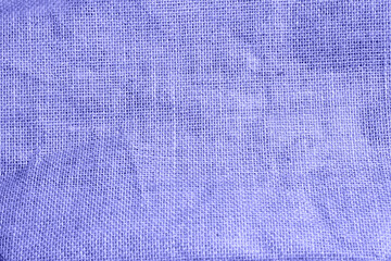 The texture of burlap, rough weave in a cage made of natural fiber, yellow-brown color. Copyspace, close-up