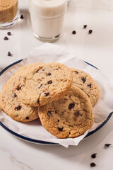 Cookies are on the dish with a glass of milk. - 474621719