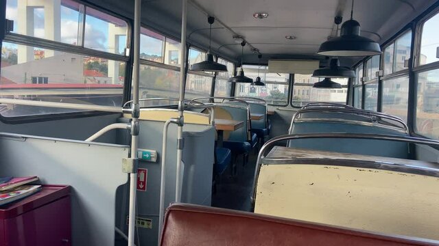 Interior Of Abandoned, Vintage And Old Bus Turned Into Cafeteria. Panning Shot