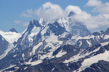 Fototapeta na wymiar Beautiful snow-capped mountain peaks of the Caucasus Mountains next to the highest peak in Europe - Elbrus