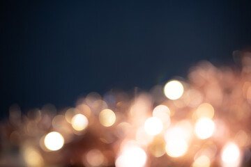 Fototapeta na wymiar Blurred Christmas lights over dark blue background