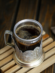 coffee in a vintage glass on a dark background
