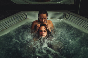 beauty relaxed woman is massaged in a whirlpool.