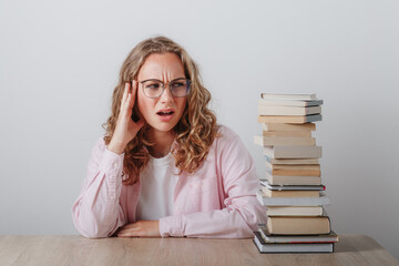 college girl with glasses has headache just thinking how much she has to learn