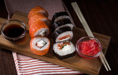 serving sushi with salmon philadelphia with sauce and ginger