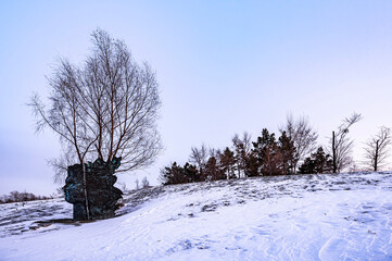 Winter scenery of the North Lake National Wetland Park in Changchun, China under the sunset