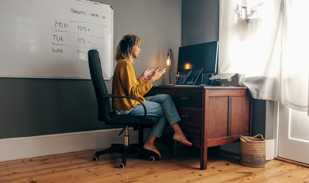 Young businesswoman talking to her colleagues on a video call