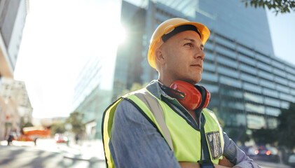 Thoughtful workman standing in the city