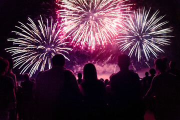 Fototapeta na wymiar Crowd watching fireworks and celebrating new year eve