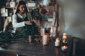 A woman makes a Christmas tree with her own hands. High quality photo