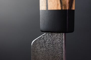 Macro - Exclusive handmade leather craft wooden Skiving knife blade . Close up tanner tool Chartermade. Black background.