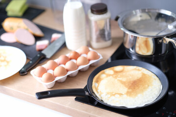 Thin pancake in a frying pan, cooking at home