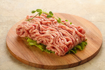 Raw minced pork meat over board