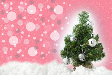 Fototapeta na wymiar Christmas decorated green tree in white snow. Happy New Year and Merry Christmas greeting card or poster, holiday cover on the pink background with bokeh and copy space