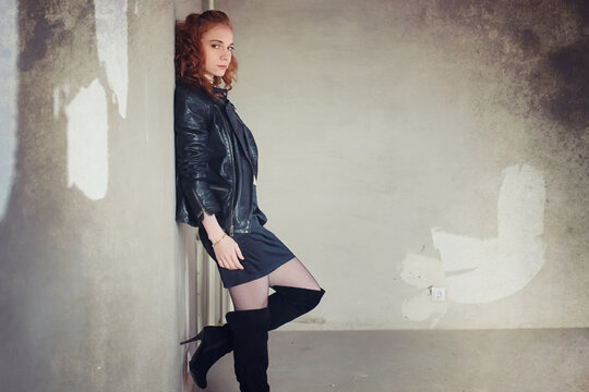 Girl addict in a leather jacket with a dose in a syringe prostitute