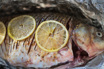 raw marinated fish with spices and lemons ready for roasting
