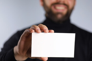 small white piece of paper in his hand man
