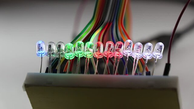 LED flashing that are connected in parallel circuit on a breadboard controlled by some programmable micro controller showing the concept of creativity