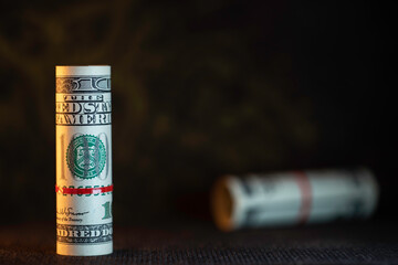 US dollars Rolled up with a rubber band. One hundred US dollars.