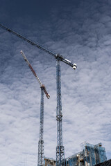 construction cranes in the surroundings of the Fira de Barcelona in Hospitalet de Llobregat in Barcelona - obrazy, fototapety, plakaty