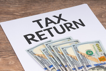 tax return application form with dollar banknotes