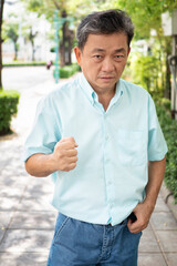 Obraz premium angry old senior man clenching aggressive fist