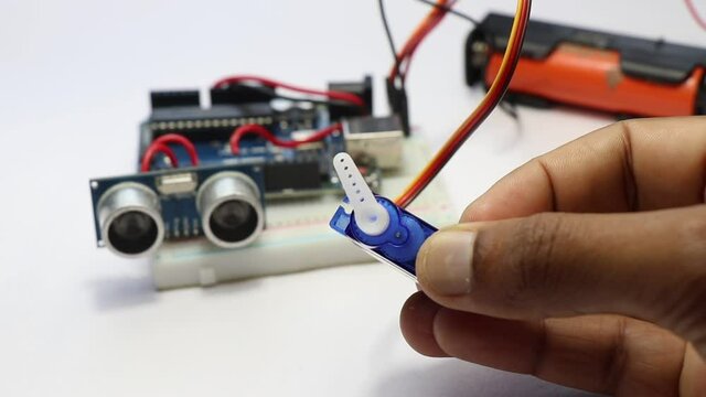 Some electronic project is made showing Micro servo shaft movements when ultrasonic distant sensor picks some obstacles. Electronic projects concept