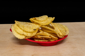 Salted Potato Wafers in Red Bowl On Wooden Table, Heap of Wafers, Copy Space, Heap of Chips, Side View
