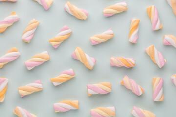 Colorful marshmallows on pastel background.