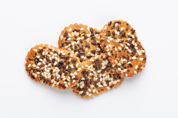 Tasty crackers with seeds on the white background.