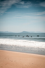 Fototapeta na wymiar surfers riding waves in atlantic ocean in south west of france