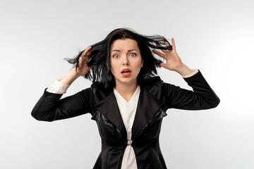 Surprised businesswoman in black formal jacket white shirt over white background. Mouth open,...