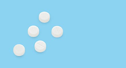 White pills on a blue background.