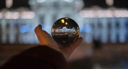 Christmas palace in the crystal ball in the hand