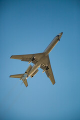 an old plane flies in the sky, the plane lands at the airport