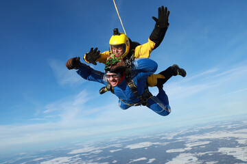Skydiving. Tandem jump. Two men are flying in the sky.