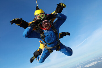 Skydiving. Tandem jump. Two men are flying in the sky.