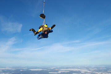 Naklejka na ściany i meble Skydiving. Tandem jump. Two men are flying in the sky.