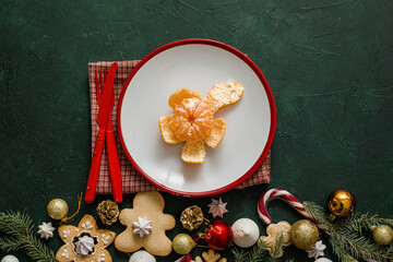 Christmas and New year setting table. White plate with mandarine and Christmas tree branches, red napkin on a red concrete background.Christmas menu. New Year eve 2022, Christmas food menu, holiday br