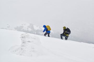 Naklejka na ściany i meble Winter hikers trapped in a deep snow