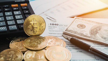 Bitcoins with US tax form 1040. Golden Bitcoin on tax form whit US money Calculator and pan. 2022 Tax form pay concept. .