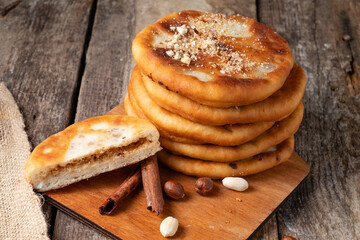 South Korean dessert hottok stuffed with nuts and brown sugar on a wooden table.