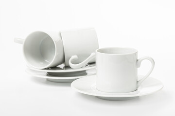 several white porcelain cup and saucer for coffee isolated on white background