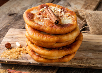 Fried dough with a sweet filling of nuts and seeds. Korean street food. Wooden background.